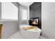 Luxurious bathroom featuring a soaking tub and sleek fireplace at 6424 S Routt St, Littleton, CO 80127
