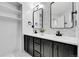 Modern bathroom with double sinks, sleek mirrors, and ample storage at 6424 S Routt St, Littleton, CO 80127