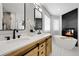 Lavish bathroom featuring double vanities, soaking tub, and fireplace at 6424 S Routt St, Littleton, CO 80127