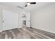 Neutral bedroom with sleek wood flooring, closet, ceiling fan, and loft access at 6424 S Routt St, Littleton, CO 80127