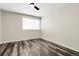 An unfurnished bedroom featuring wood-look flooring and a ceiling fan at 6424 S Routt St, Littleton, CO 80127