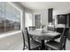 Dining room with large windows providing ample natural light and a modern table with seating at 6424 S Routt St, Littleton, CO 80127