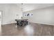 Spacious dining area with a large table, modern lighting, and white walls at 6424 S Routt St, Littleton, CO 80127