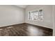 A light, bright, and empty room with hardwood floors, and modern window at 6424 S Routt St, Littleton, CO 80127