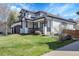 Beautiful two-story house featuring well-maintained lawn, and black and white trim at 6424 S Routt St, Littleton, CO 80127