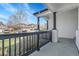 A beautiful view of the front porch area with elegant black trim, stone columns, and new railings at 6424 S Routt St, Littleton, CO 80127