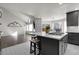 Open concept kitchen with granite countertops, stainless appliances, and seating at the center island at 6424 S Routt St, Littleton, CO 80127