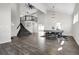 Open living space featuring a staircase, new hardwood floors, and a dining table with seating at 6424 S Routt St, Littleton, CO 80127