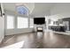 Open-concept living room with vaulted ceilings, fireplace, and view to modern kitchen at 6424 S Routt St, Littleton, CO 80127