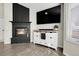 Inviting living room featuring a cozy fireplace and entertainment center at 6424 S Routt St, Littleton, CO 80127