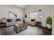Bright living room with neutral colored walls, modern furniture, and a decorative area rug at 6424 S Routt St, Littleton, CO 80127