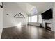 Bright living room featuring vaulted ceilings, modern fireplace, and oversized windows at 6424 S Routt St, Littleton, CO 80127