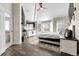 Large primary bedroom with a fireplace, a sitting area near the windows, and a ceiling fan at 6424 S Routt St, Littleton, CO 80127