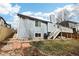 Inviting backyard with stone and brick accents, a deck with stairs, and mature landscaping at 4644 W 112Th Ct, Westminster, CO 80031