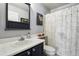 Bathroom featuring a sink, vanity with cabinet, mirror, toilet, shower curtain, and artwork at 4644 W 112Th Ct, Westminster, CO 80031