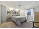 Bedroom featuring a cozy bed, patterned bedding, and a view to the outdoors through a sunny window at 4644 W 112Th Ct, Westminster, CO 80031