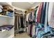 Organized walk-in closet with shelves, hanging rods, clothes, and shoes at 4644 W 112Th Ct, Westminster, CO 80031