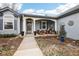 Inviting front porch with stylish seating area and landscaped garden at 4644 W 112Th Ct, Westminster, CO 80031