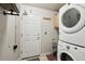 Laundry room featuring a washer, dryer, door, shelving, and hanging rack at 4644 W 112Th Ct, Westminster, CO 80031