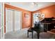 Office/flex room with an orange wall, a piano, and large closet space at 4644 W 112Th Ct, Westminster, CO 80031