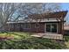 Beautiful backyard featuring a brick house, a wood pergola patio, and a well-manicured lawn at 3400 Moore St, Wheat Ridge, CO 80033