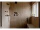Modern bathroom features a wood paneled walk-in shower, a built in niche and a marble shower seat at 3400 Moore St, Wheat Ridge, CO 80033