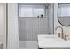 Stylish bathroom featuring a tub with shower and a marble countertop sink at 3400 Moore St, Wheat Ridge, CO 80033