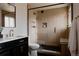 Modern bathroom featuring a walk-in shower, wood-look tiled walls, and elegant fixtures at 3400 Moore St, Wheat Ridge, CO 80033