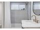 Beautiful bathroom featuring a tiled shower and tub, white marble countertops, and modern brass fixtures at 3400 Moore St, Wheat Ridge, CO 80033