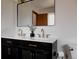 Elegant bathroom showcasing dual sinks, marble countertops, and brass fixtures for a luxurious feel at 3400 Moore St, Wheat Ridge, CO 80033