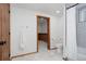 Bright bathroom featuring a tub with a shower curtain and wood trim at 3400 Moore St, Wheat Ridge, CO 80033