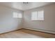 Bright bedroom with hardwood floors, two windows, and baseboard heating, ready for personalization at 3400 Moore St, Wheat Ridge, CO 80033