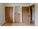 Bedroom featuring closet storage with wooden doors and convenient built-in drawers at 3400 Moore St, Wheat Ridge, CO 80033