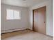 Bedroom showcasing a closet with sliding doors, a window, and hardwood floors at 3400 Moore St, Wheat Ridge, CO 80033