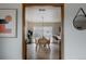 Stylish dining area with light wood floors, table, chairs, and modern lighting fixture at 3400 Moore St, Wheat Ridge, CO 80033