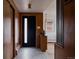 Stylish foyer with modern lighting, wood paneling, and a view to the living space at 3400 Moore St, Wheat Ridge, CO 80033