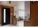 Inviting foyer with modern decor, sleek lighting, and view into a stylish living room at 3400 Moore St, Wheat Ridge, CO 80033