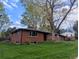 Charming single-Gathering home with brick exterior, well-maintained lawn, and mature trees at 3400 Moore St, Wheat Ridge, CO 80033