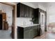 Modern kitchen featuring dark green cabinets, stainless appliances, and an eat in dining area at 3400 Moore St, Wheat Ridge, CO 80033