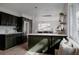 Modern kitchen boasts sleek dark cabinets, stainless steel appliances, and a stylish island at 3400 Moore St, Wheat Ridge, CO 80033