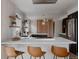 Modern kitchen featuring a large center island, stainless steel appliances, and open shelving at 3400 Moore St, Wheat Ridge, CO 80033