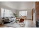 Bright living room with large windows, hardwood floors, comfortable seating, and brick fireplace at 3400 Moore St, Wheat Ridge, CO 80033