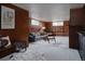 Cozy wood paneled living room with a gray sofa, patterned rug, and modern decor, perfect for relaxing at 3400 Moore St, Wheat Ridge, CO 80033