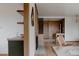 Stylish living room with a fireplace and wood accents open to a modern kitchen and hallway at 3400 Moore St, Wheat Ridge, CO 80033