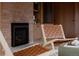 Cozy living room with a brick fireplace, comfortable seating, and built-in shelving at 3400 Moore St, Wheat Ridge, CO 80033