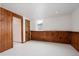 Bright, spacious room with wood paneling, white walls, and a cozy atmosphere at 3400 Moore St, Wheat Ridge, CO 80033