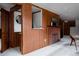 Living room boasts wood accents, stylish decor, a brick fireplace, and an open pass-through at 3400 Moore St, Wheat Ridge, CO 80033