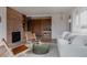 Cozy living room with a brick fireplace, comfortable seating, and built-in shelving at 3400 Moore St, Wheat Ridge, CO 80033