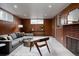 Comfortable living room features wood paneling, a gray sofa, modern decor and plenty of natural light at 3400 Moore St, Wheat Ridge, CO 80033
