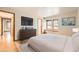 Bright bedroom with two windows, hardwood floors, and a minimalist design aesthetic at 23678 Pondview Pl # D, Golden, CO 80401